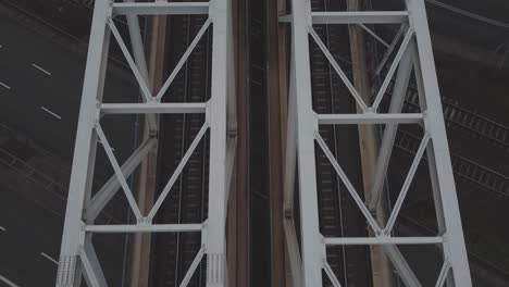 close up top down tracking drone video of train tracks on a bridge