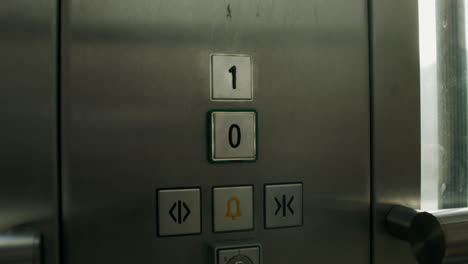 person pressing elevator buttons