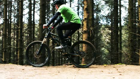 mountain biker riding bicycle in forest