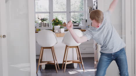 young downs syndrome man having fun dancing at home