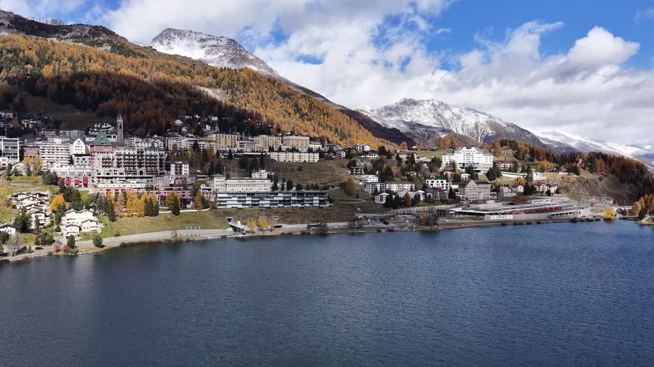St. Moritz lakeside in Engadin Graubünden Switzerland drone view with autumn colors, clear water and mountain backdrop