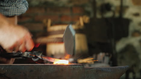 A-Blacksmith-Works-In-A-Forge-A-Close-Up-Of-The-Anvil-And-The-Red-Hot-Billet-On-Which-The-Hammer-Bea