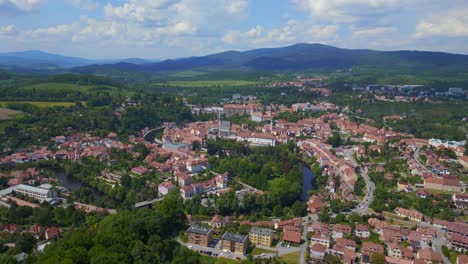 Beautiful-aerial-top-view-flight-mountain-overview-Hill-town-Panorama,-Krumlov-Czech-Republic-Summer-2023