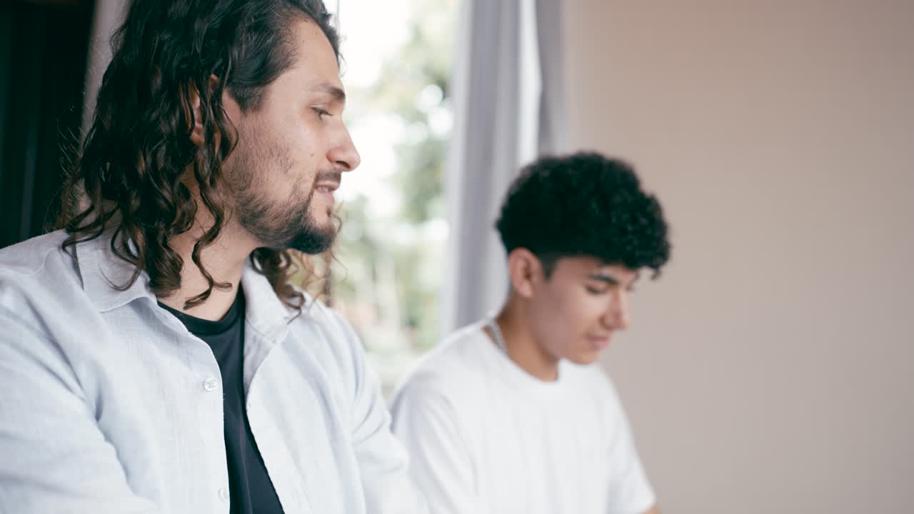 Two men with curly hair