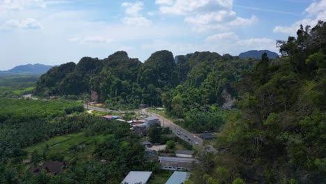 Tropical-landscape-karst-mountains-road-palm-trees