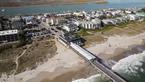 Wrightsville-Beach,-North-Carolina-orbiting-aerial-around-pier-and-shorefront