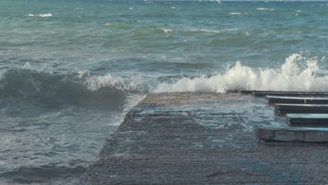 sea waves breaking up the slipway on a stormy day