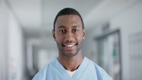 Portrait-of-happy-african-american-male-doctor-smiling,-slow-motion