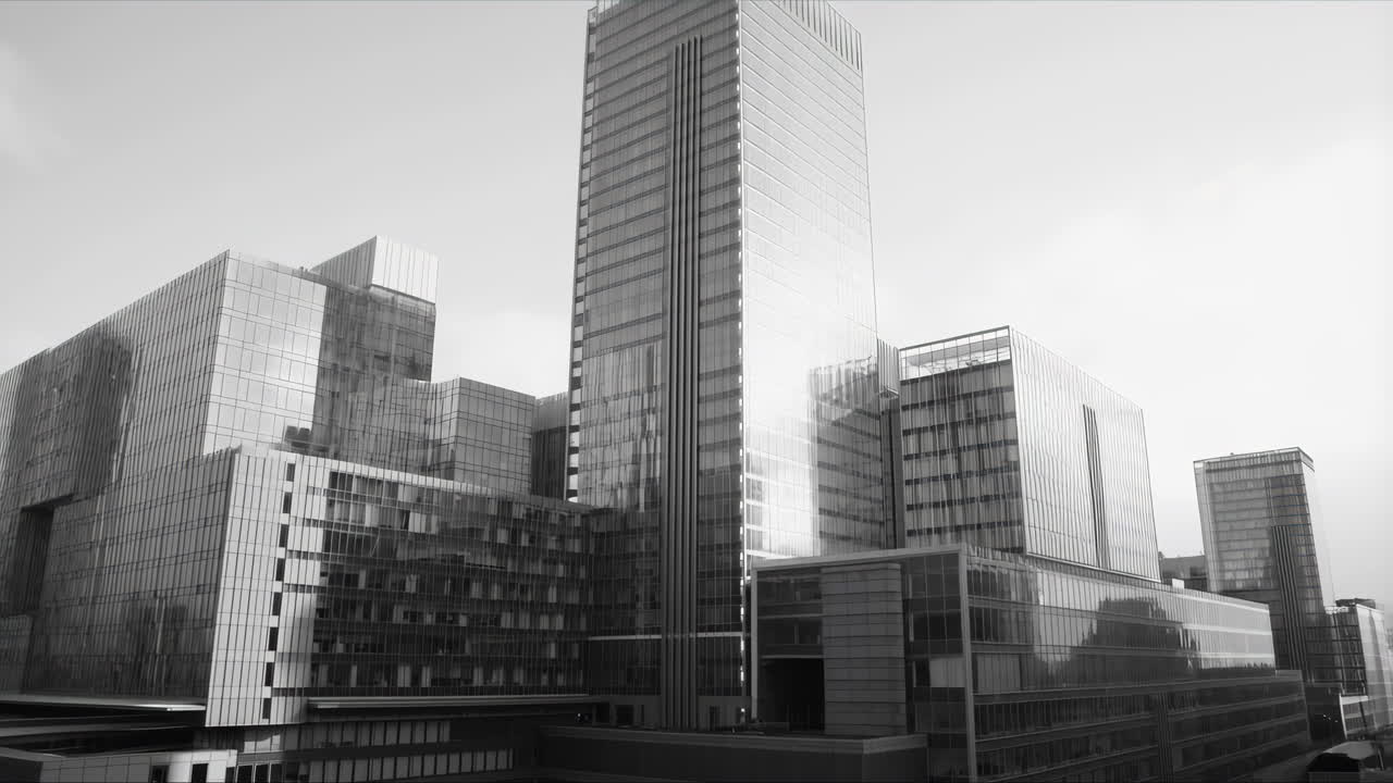 Paneo ascendente monocromático de edificios de oficinas de cristal contemporáneos