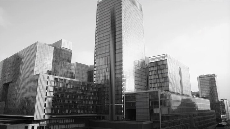 Panoramica monocromatica verso l'alto di moderni edifici per uffici in vetro