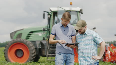 young farmers communicate in the field using a tablet