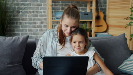 mother and daughter using a tablet together at home