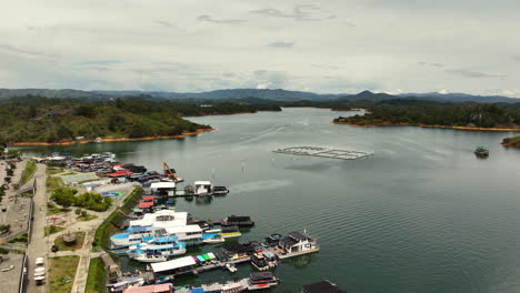 aerial view rising over a marina at the peñol-guatapé reservoir in colombia