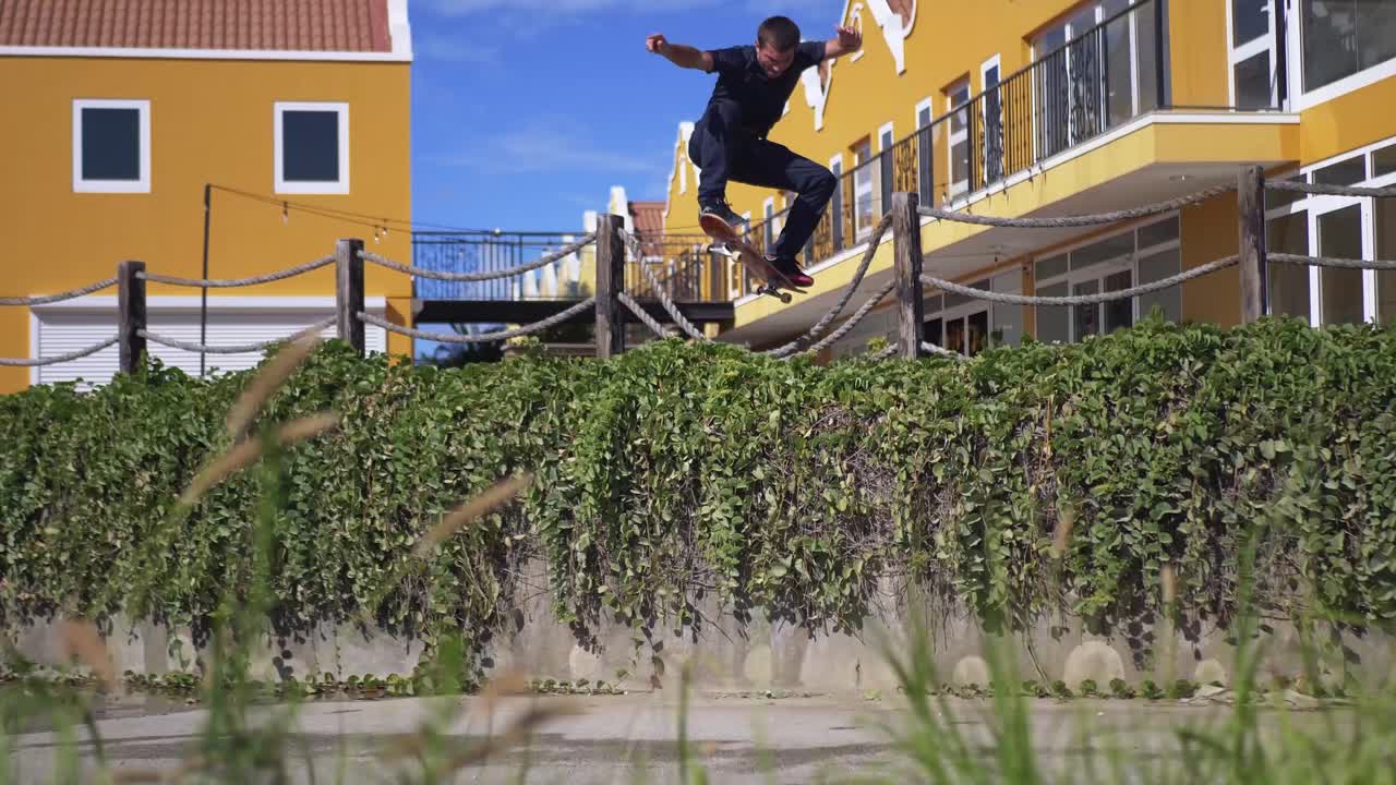 Skater ollies over a big gap while traveling