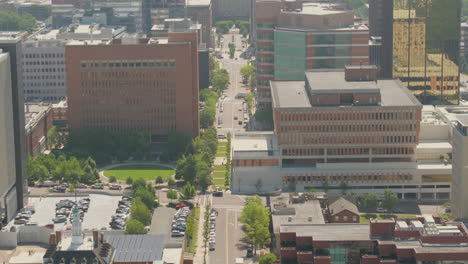 aerial view of city skyline with a tilt down to reveal the city street below