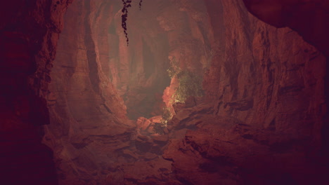 una cueva de roca roja con una luz brillando en la distancia