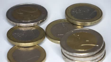 loopable selective focus view on many euro coins in close up view spinning in circle .