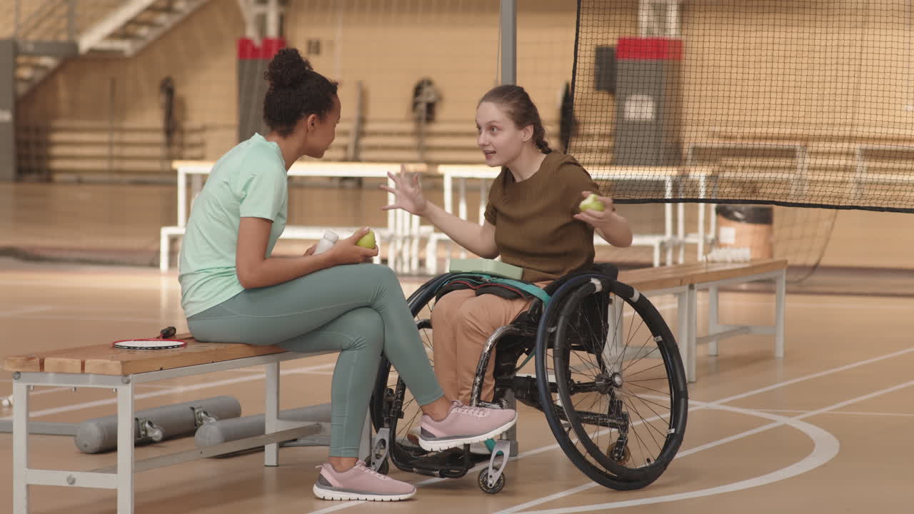 Female Athletes Having Conversation after Training