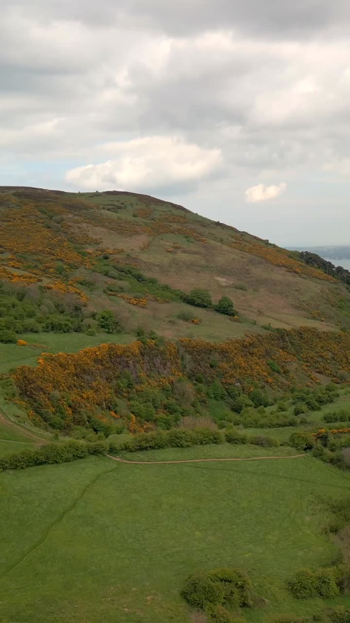 Slow reversing social ratio aerial video of Cavehill in Belfast, County Antrim in Northern Ireland. Filmed in 1080x1920, 60FPS and with Rec709 color
