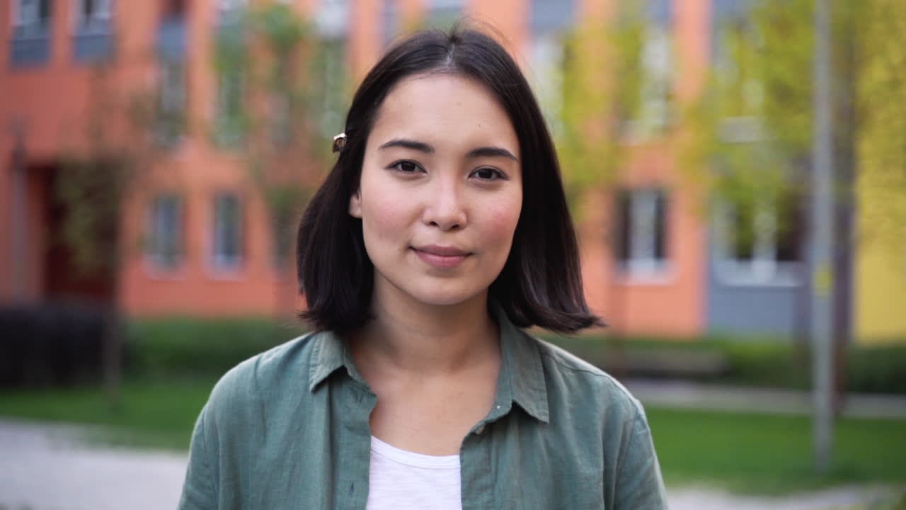 Outdoor Portrait Of A Beautiful Japanese Girl Smiling And Walking Towards Camera