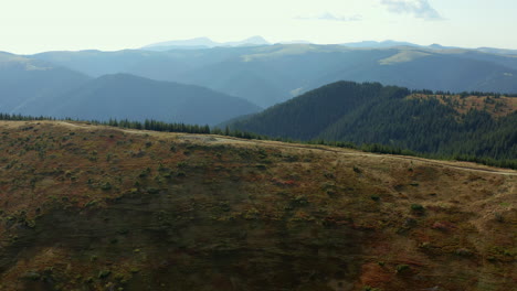 Aerial-beautiful-hills-road-way-for-travellers-stunning-rocky-mountains-panorama