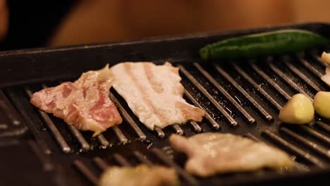 sizzling meat and asparagus on a hot grill