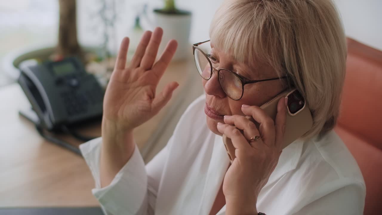 Senior woman on phone call in office