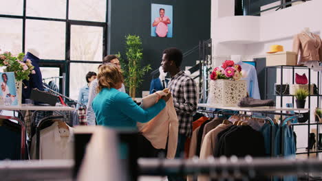 stylish employee helping couple