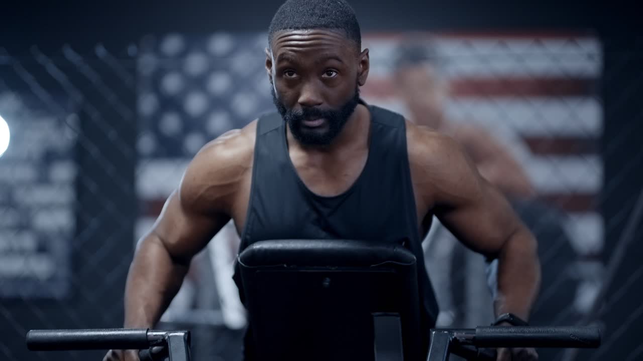 Athletic African American performs Incline Chest Pulls MID SHOT