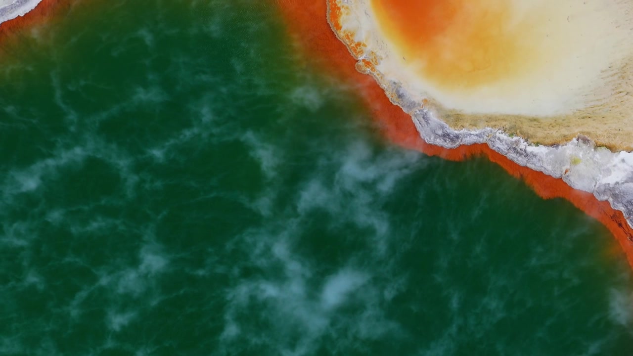 Aerial top down view of a vibrant geothermal hot spring in Rotorua, New Zealand, North Island, featuring emerald water and colorful mineral deposits, ideal for travel, geology and nature backgrounds.