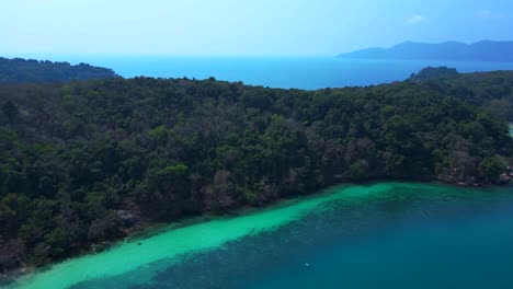 tropical island landscape with turquoise waters and dense forest beach cottage on koh wai island in thailand. fabulous aerial view flight panorama overview drone
