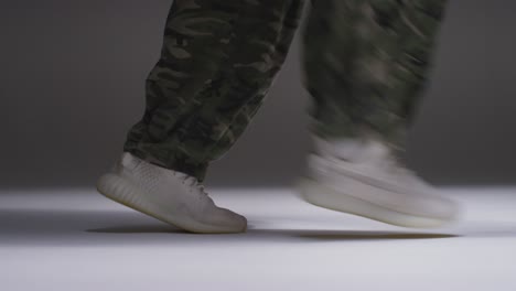 Close-Up-Studio-Shot-Showing-Feet-Of-Woman-Dancing-With-Low-Key-Lighting-Against-Grey-Background-1