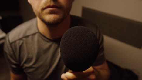 simulating interview or public statement in close-up studio setting with neutral expression
