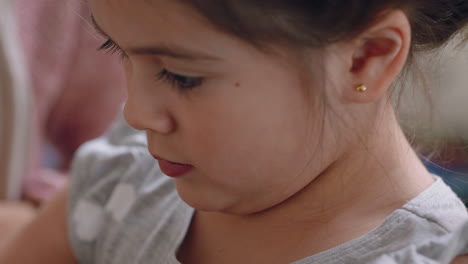 cute little girl helping mother bake in kitchen mixing ingredients breaking eggs into bowl preparing recipe at home with mom