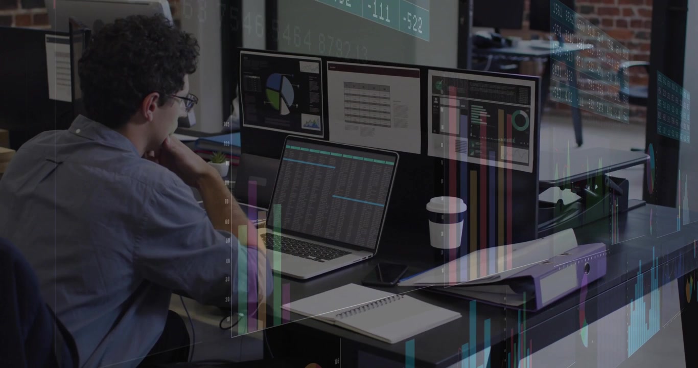 Live data feed updating on monitors, male analyst leaning and studying animated charts for trading