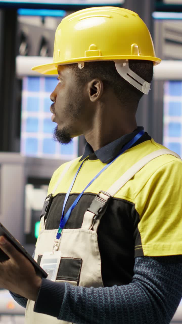 Vertical video Smart factory specialist testing automated systems, monitoring operations