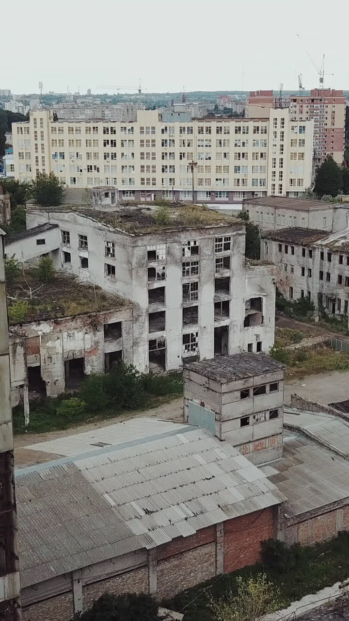 Flight over the destroyed factory. Old industrial building for demolition. Aerial view Vertical video