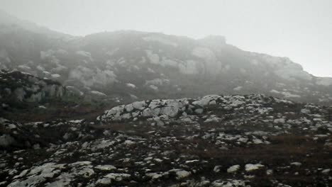 rainy mist floating across rugged rocky mountain slopes on top of holyhead mountain north wales