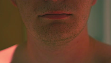 close-up shot of a man removing his transparent invisalign retainer to clean them