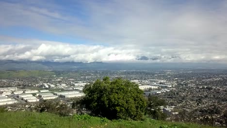 aerial views of freeways and suburban sprawl near green foothills