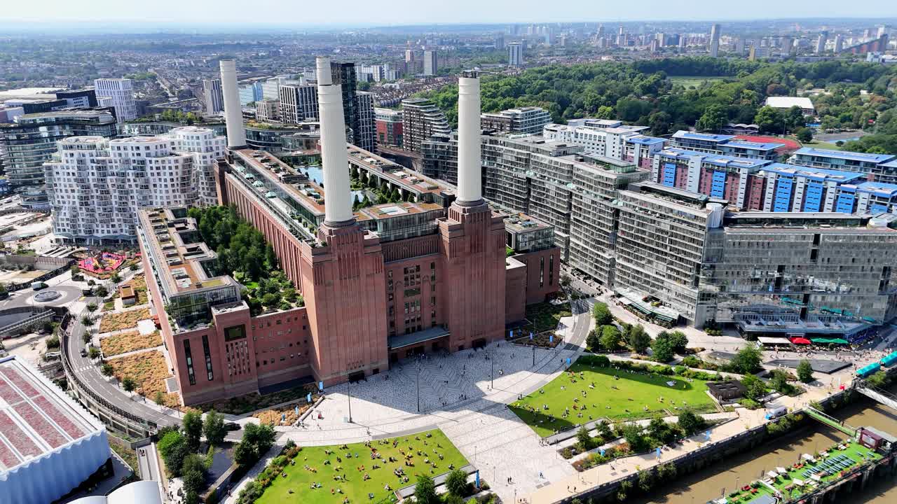 Scenic aerial shot over Battersea in London, revealing the redeveloped Power Station, luxury flats, and vibrant riverside scene along the Thames