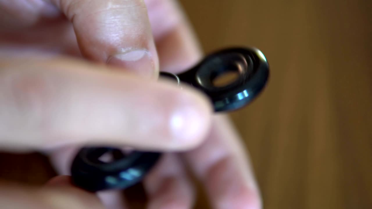 Hand spinner, or fidgeting spinner, rotating on child's hand