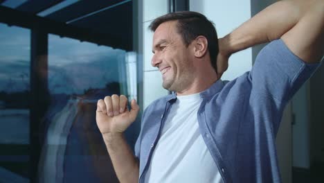 hombre feliz relajándose después de un día de trabajo. hombre sonriente tratando de estirarse.