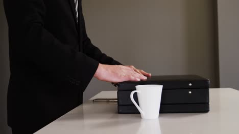 businessman closing a briefcase