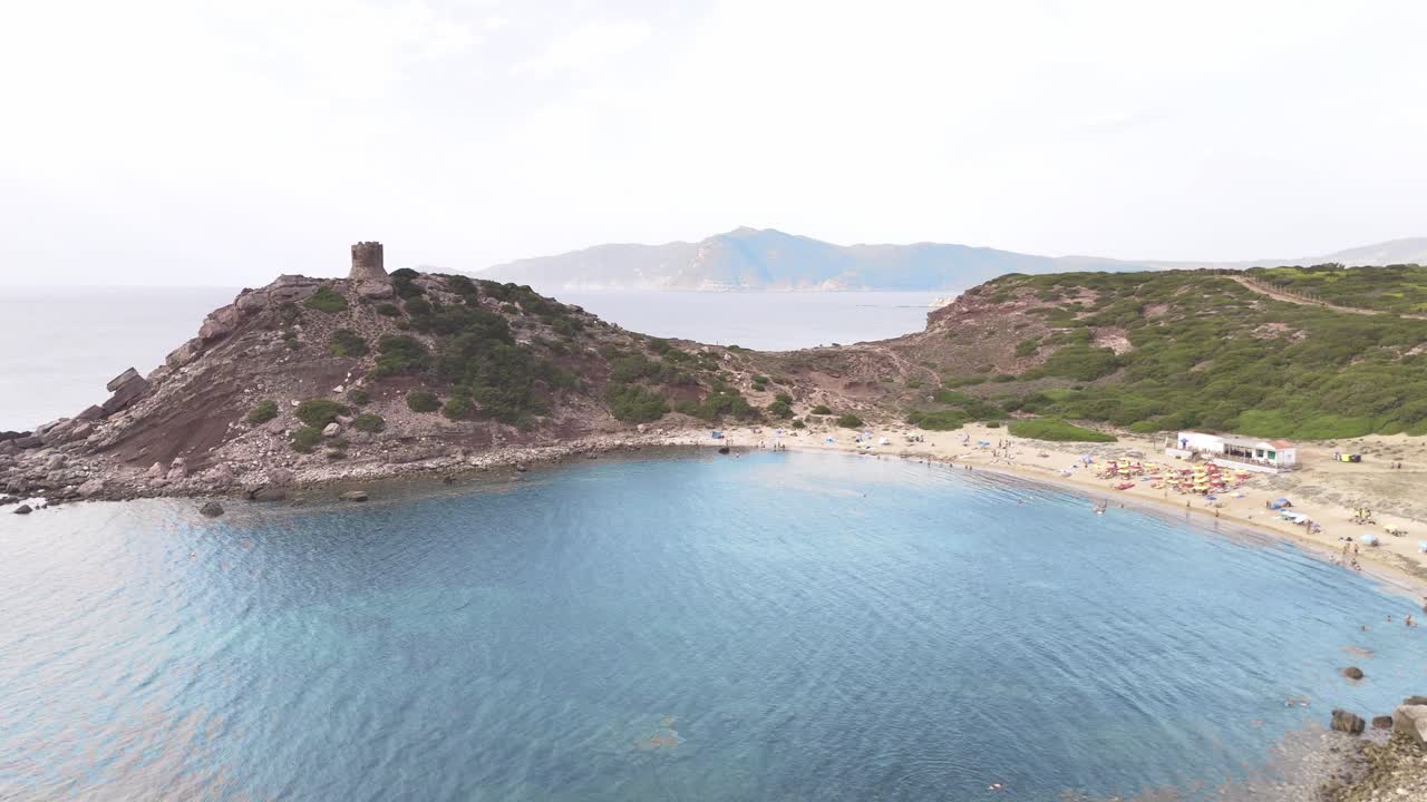 Sea Bay in Cala Gonone with a Watchtower on the Mountain AERIAL
