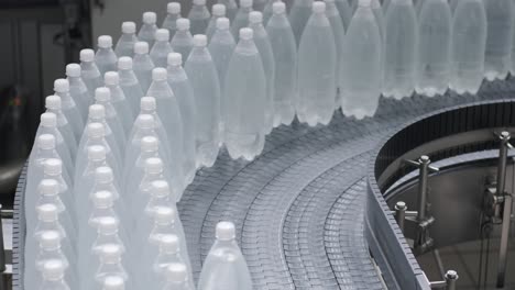 conveyor belt with bottles of drinking water at a modern beverage plant