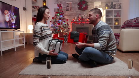 zoom in shot of couple exchanging gifts