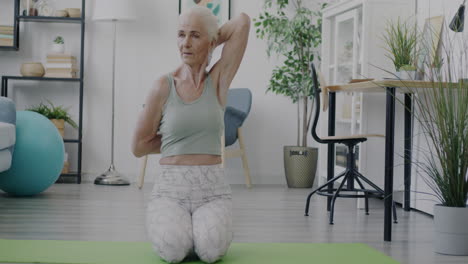 senior woman doing yoga exercises at home