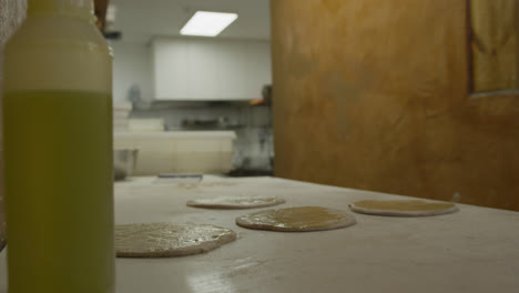 african american man making pizza dough