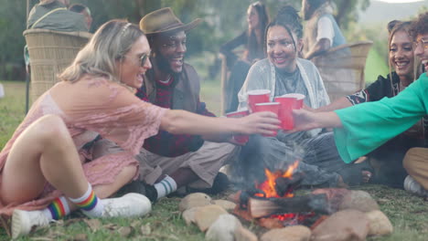 friends cheers at music festival with drinks